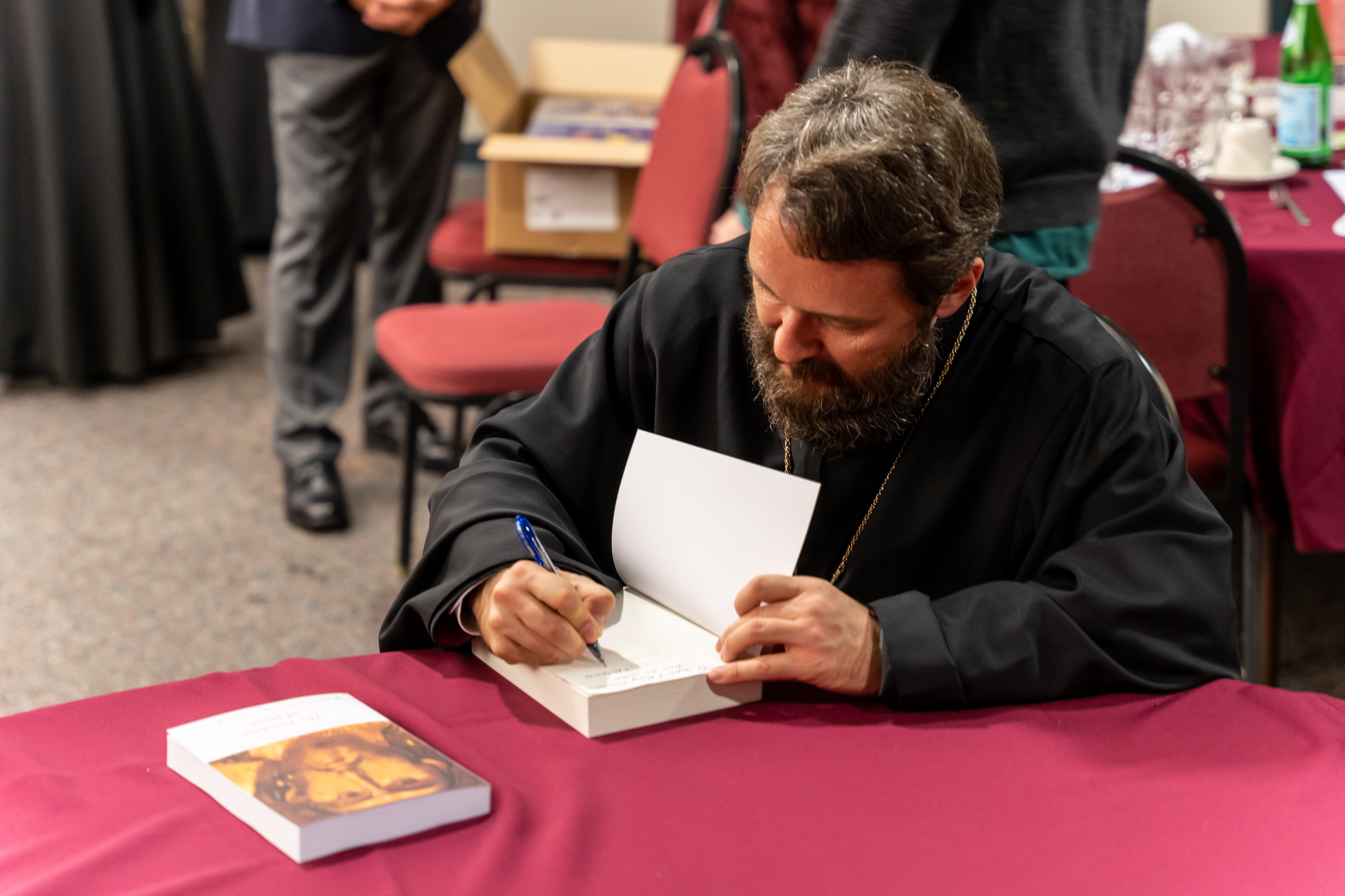 Metropolitan Hilarion signs copies of his books