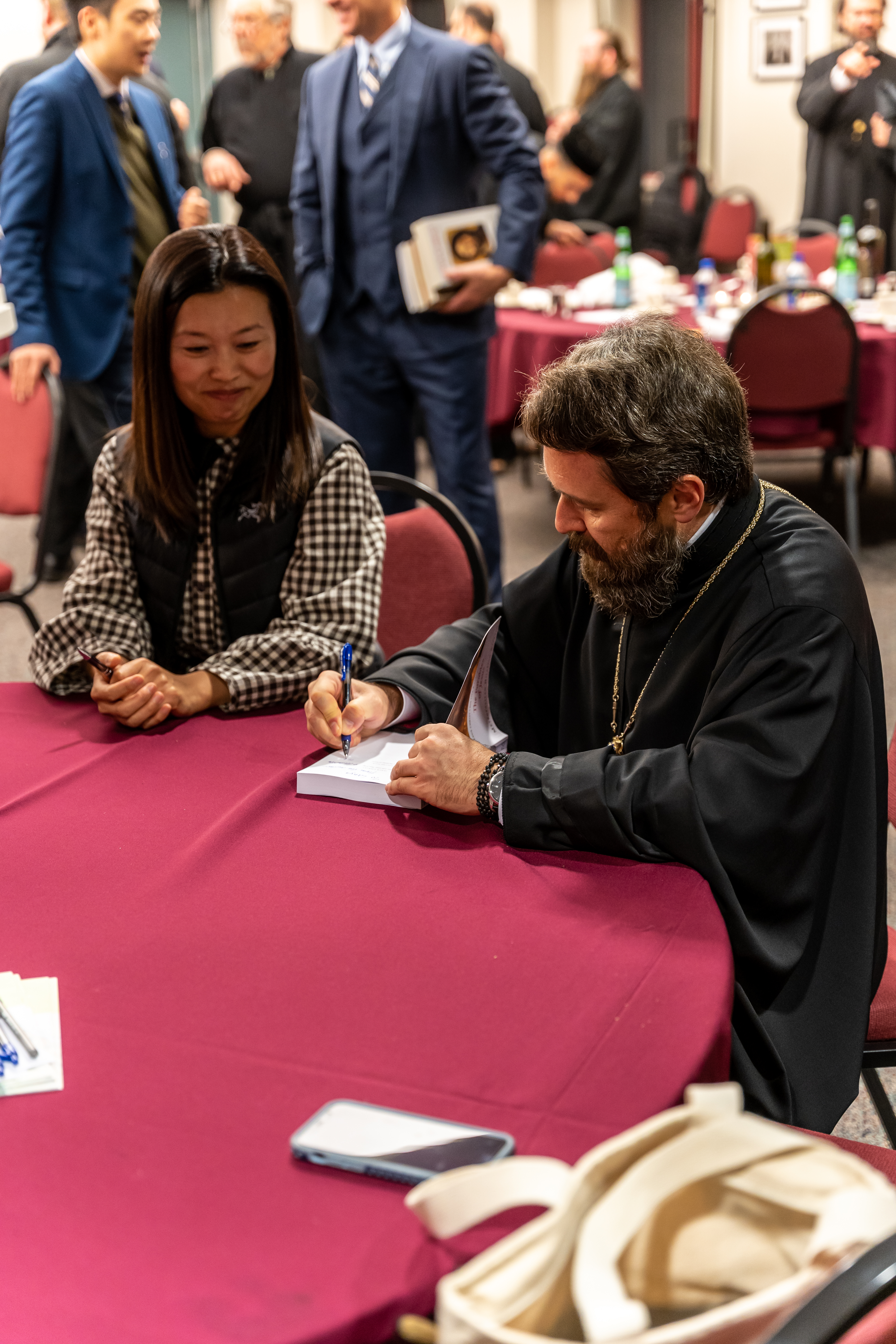 Metropolitan Hilarion signs copies of his books