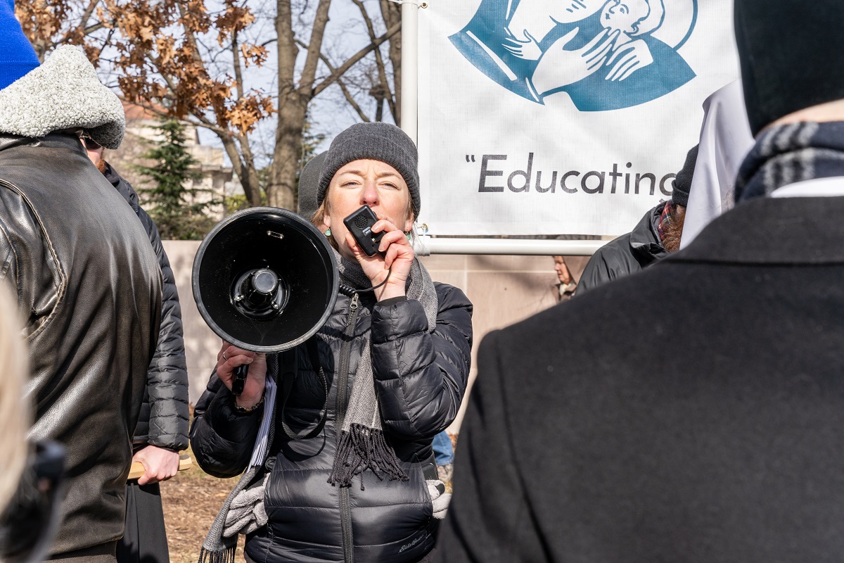 Woman speaks through a megaphone