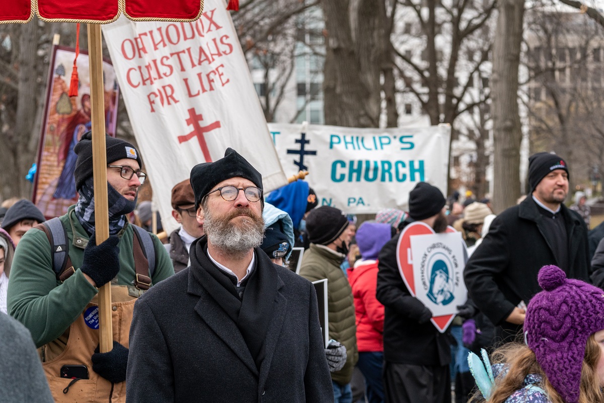 Marchers look on