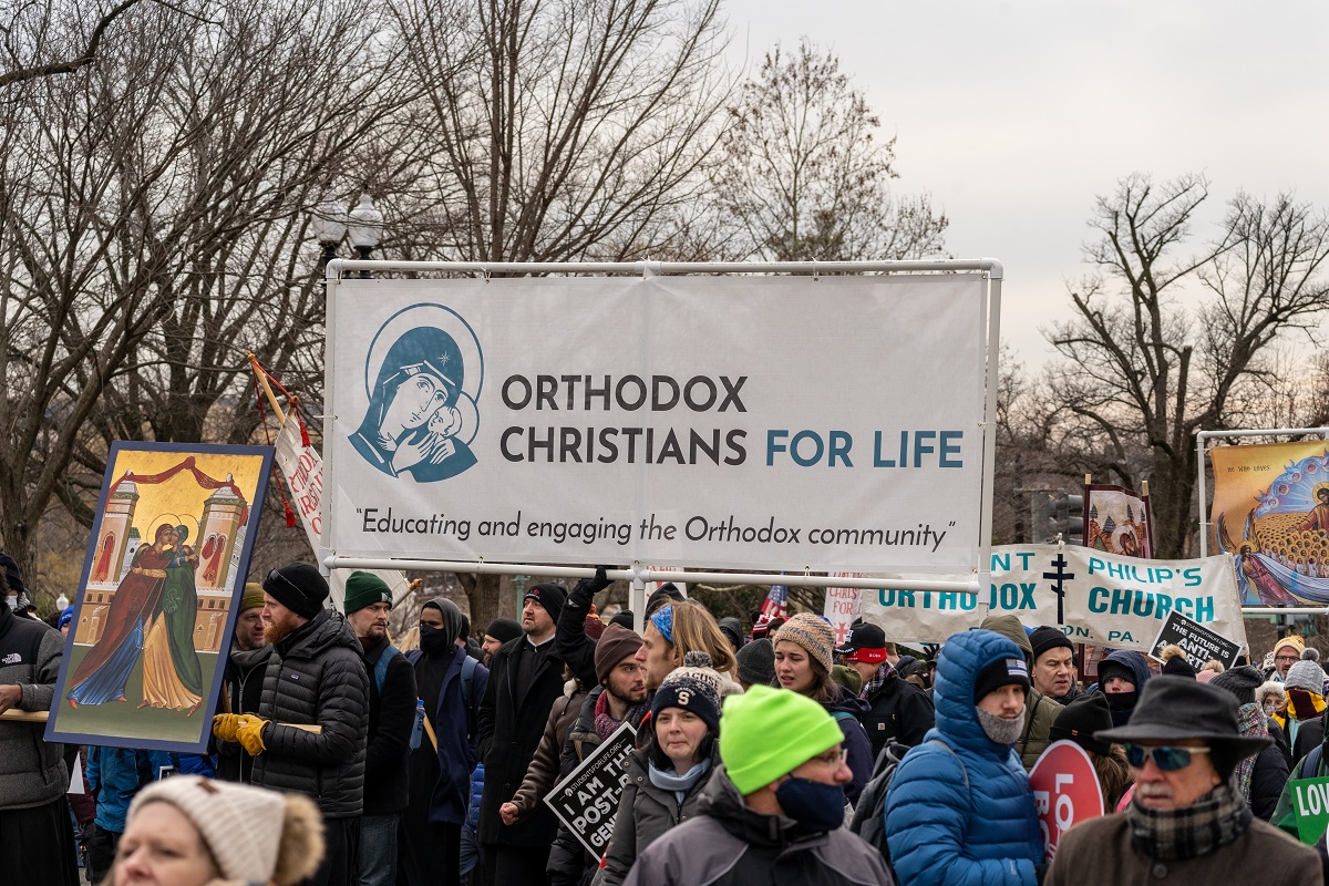 Crowd marches with OCL banner