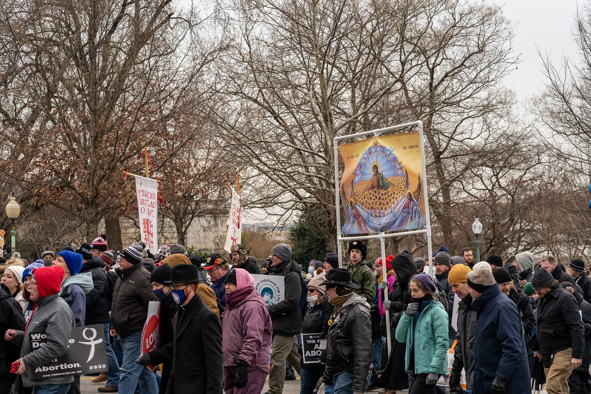 Crowd marches with icon