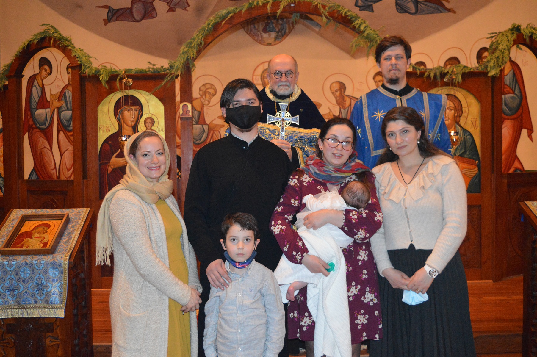 Family with clergy following the baptism