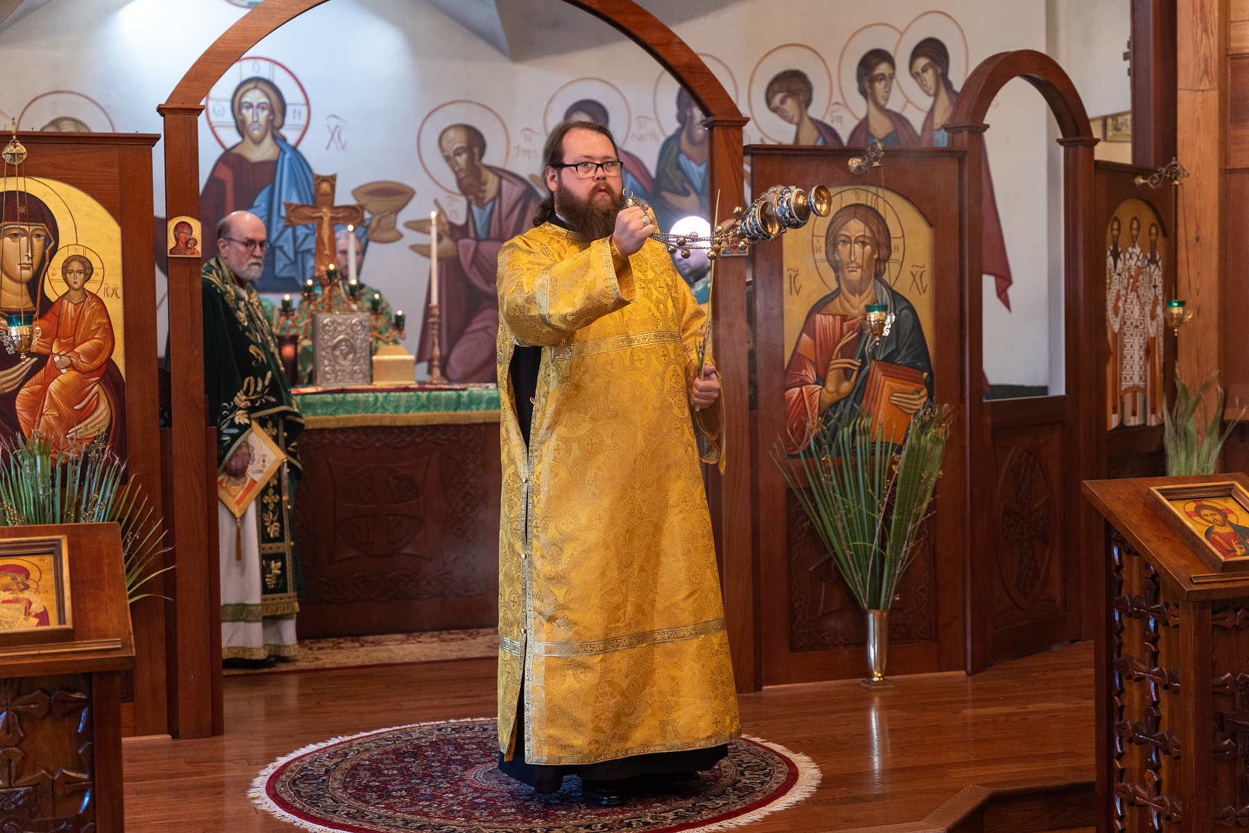 Dn David Galloway swings censer during Palm Sunday liturgy