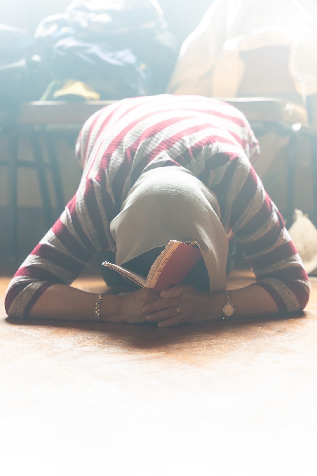 A woman prostrates during service