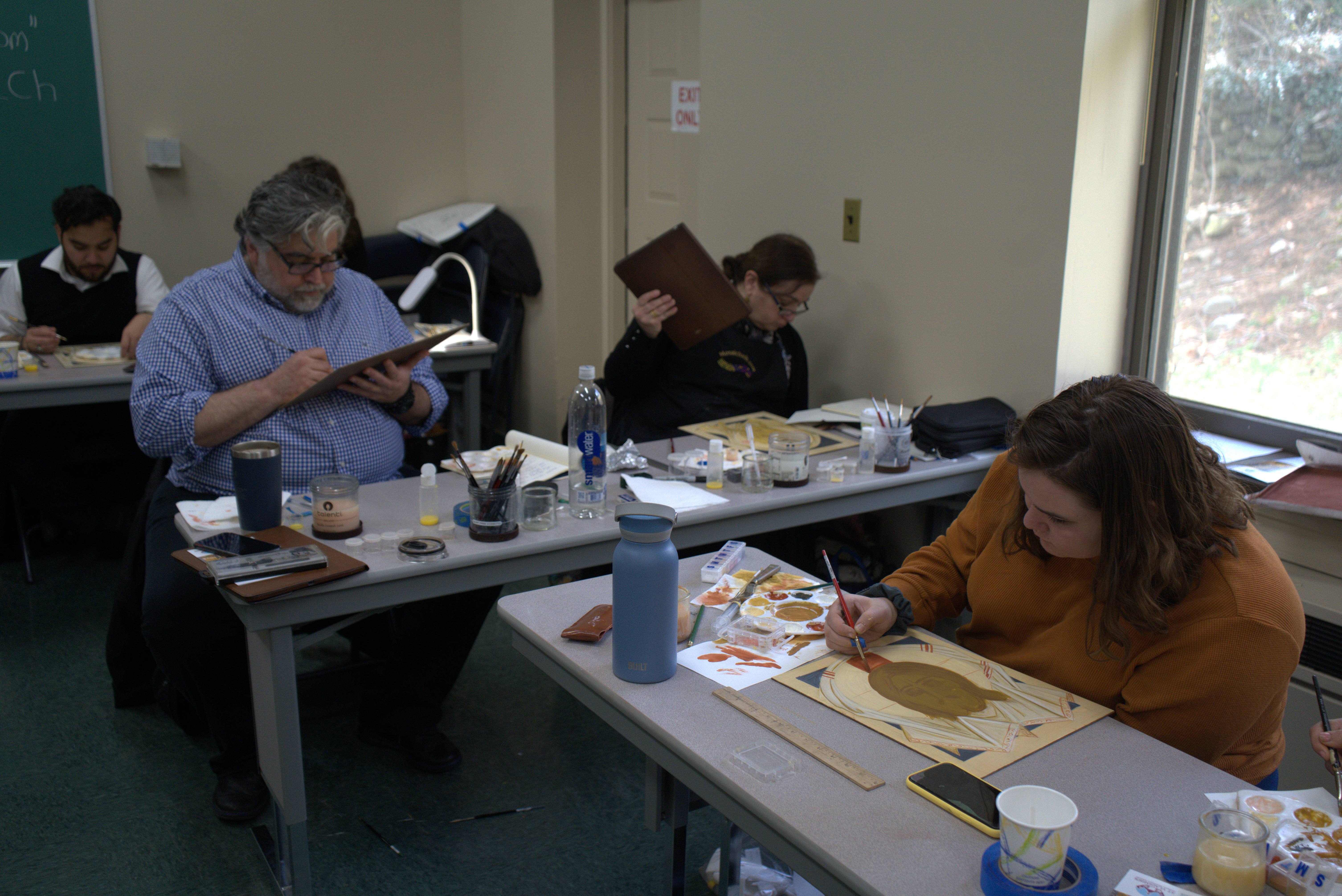 Male and female students work on projects during the workshop