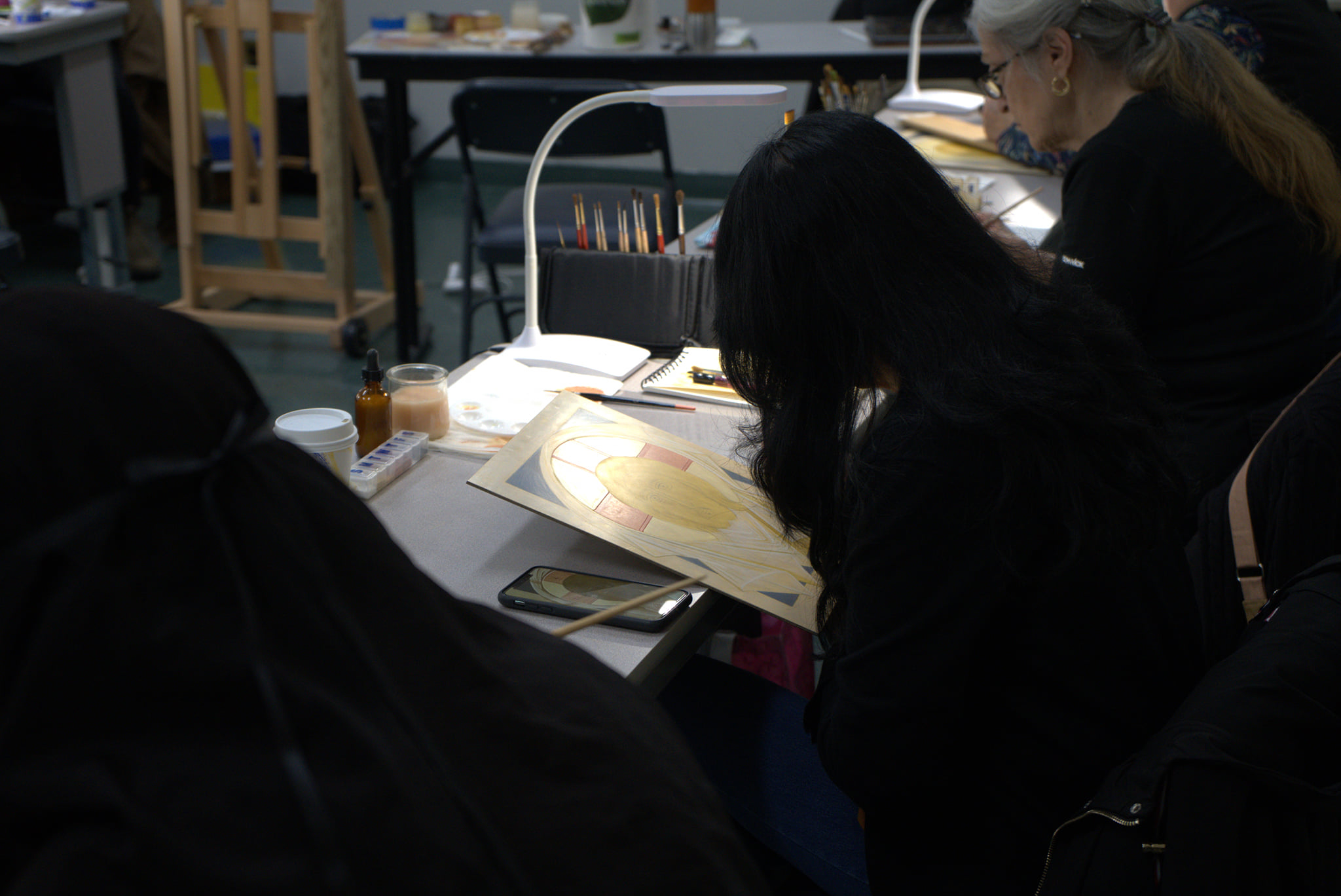 Student works on icon of Christ at workshop