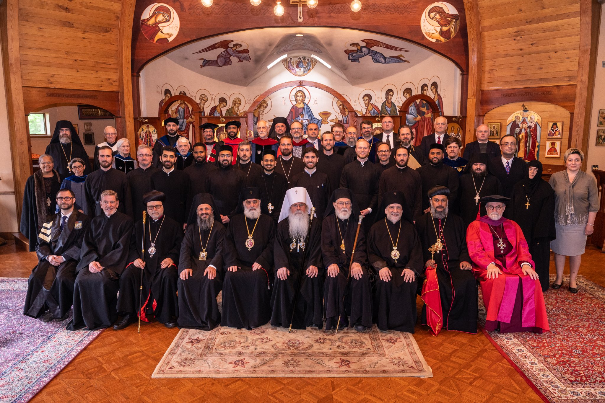 Graduating class with faculty, heirarchs, trustess, and distinguished guests