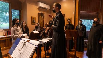Dr Harrison Russin conducts the choir at Three Hierarchs Chapel