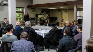 Faculty members and guest scholars in discussion 