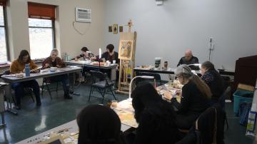 Dr Kordis oversees students painting icons