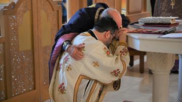 Priest candidate kneels at the altar during his ordination