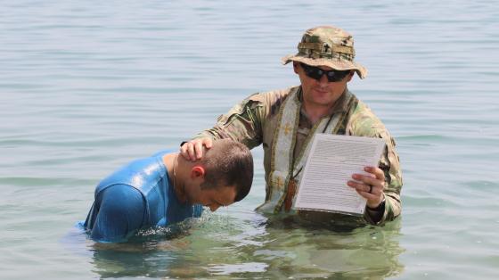 Fr James baptizes a soldier in the Gulf of Aden
