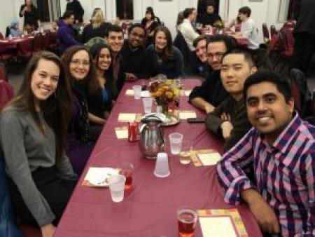 Students sitting at a table for an event