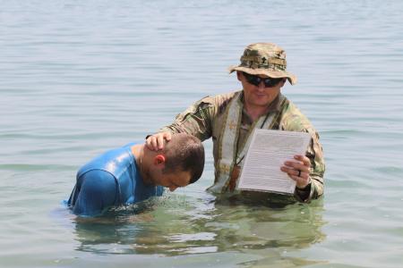 Fr James baptizes a soldier in the Gulf of Aden