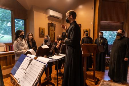 Dr Harrison Russin conducts the choir at Three Hierarchs Chapel