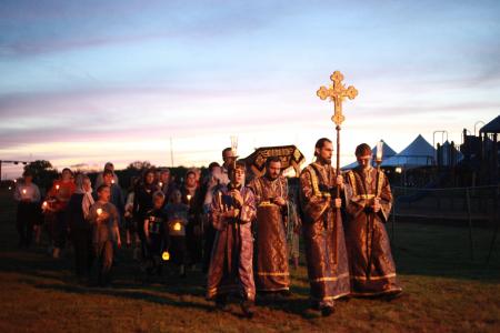 Procession with the Cross in the dim light of dusk