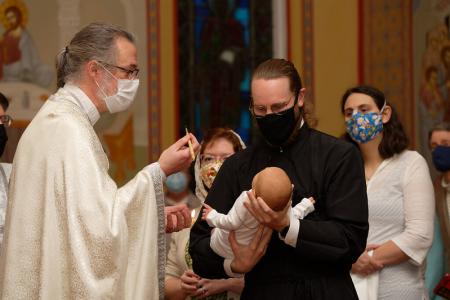 Fr Theophan prepares to anoint the child with Holy Chrism