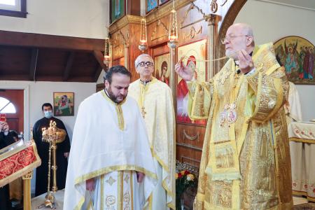Met. Joseph presents a cross to Fr Charles