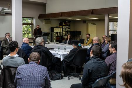 Faculty members and guest scholars in discussion 