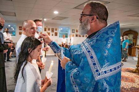 Fr Christopher Foley receives group of catechumens into the Church