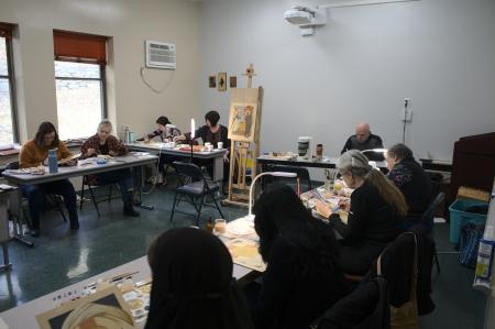 Dr Kordis oversees students painting icons