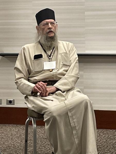 Archbishop Alexander seated at the special session