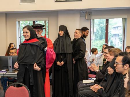 Fr Chad giving a student their Masters hood